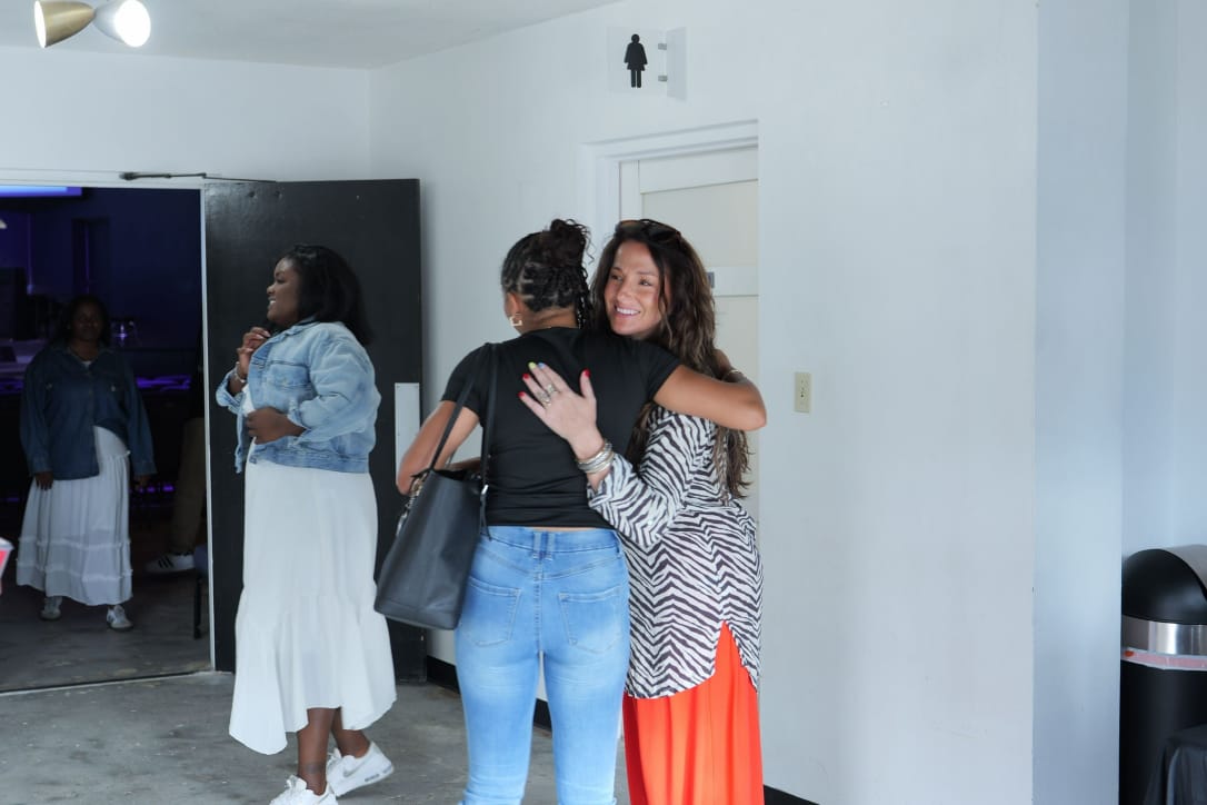 Guests embracing in welcome at Vertical Tampa