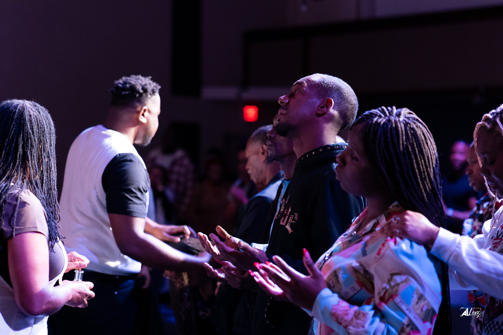 The Vertical Tampa church family praying together