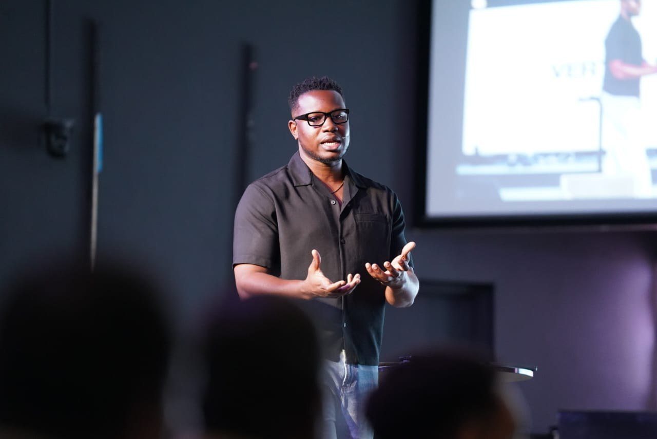Pastor JD Bellamy speaking on stage at Vertical Tampa