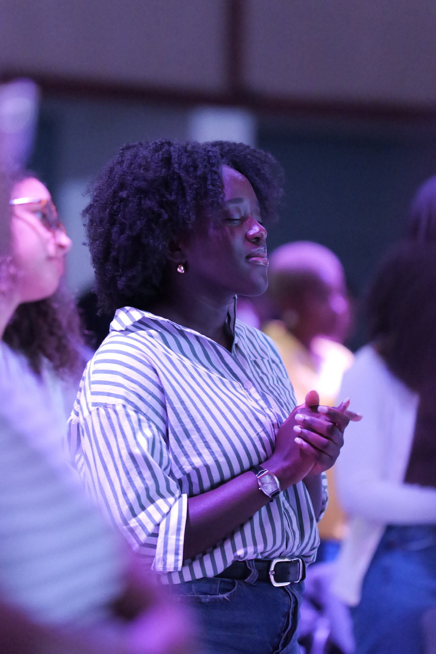A woman praying during worship at Vertical Tampa